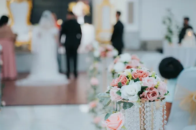 Wedding aisle with floral arrangements at M and N Event Hall
