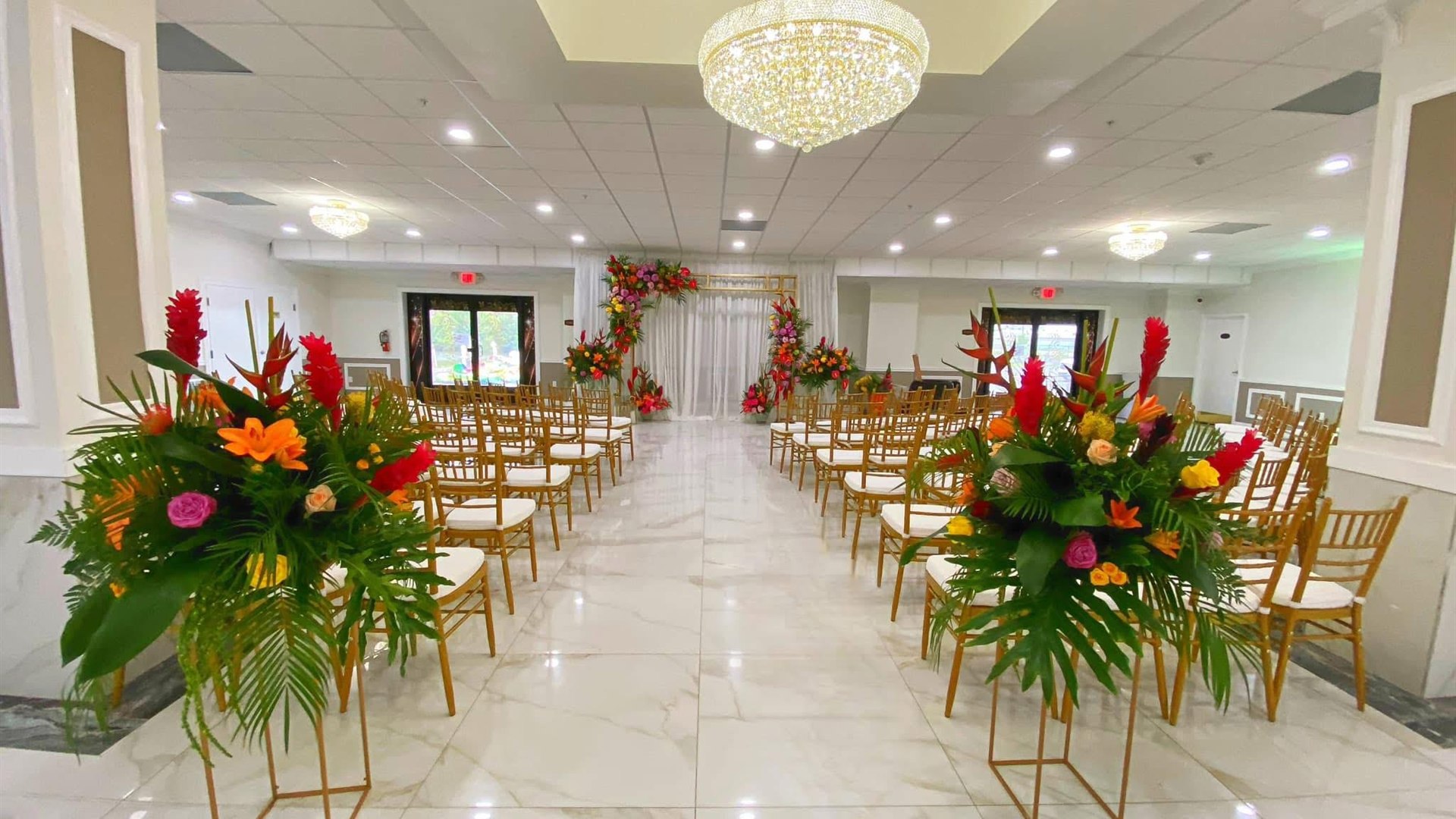 Grand ballroom ceremony aisle with chandeliers at M and N Event Hall